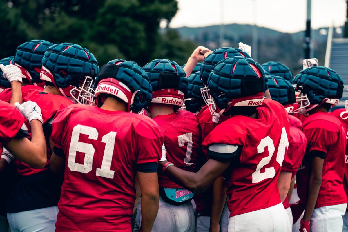 The Falcons huddle before their first scrimmage of the season against Evergreen on Sept. 5th.