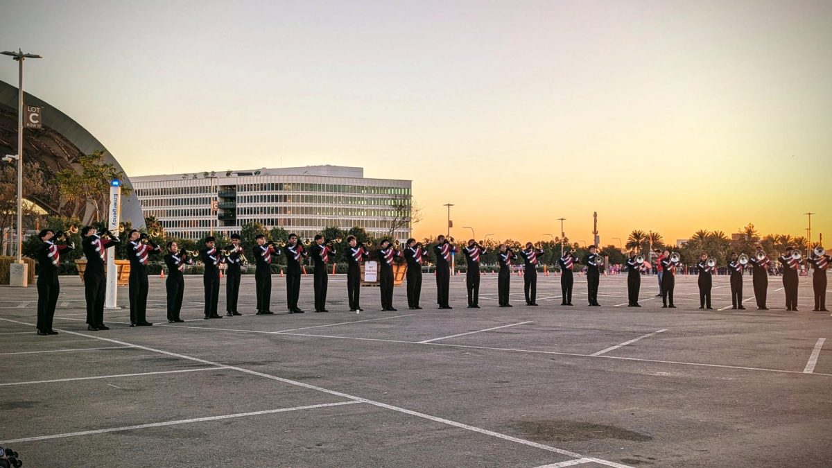 The brass section plays a tuning chorale in the SoFi Stadium warm-up parking lot in order to ensure that their pitch stays stable during their time on the field.	