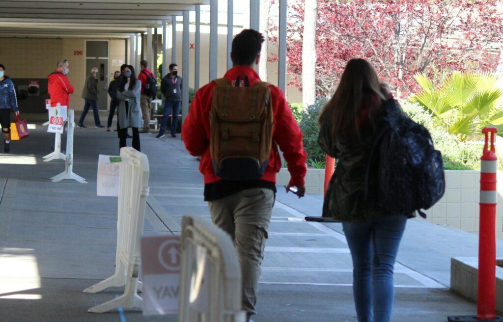 Students and staff walk by the student center during Phase 3A in March. 