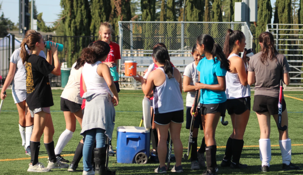 Girl’s team chatting and having fun during a quick break from practice