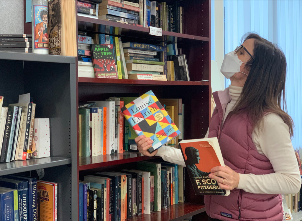 English teacher Amy Keys browses the books on her classroom library shelves.

 