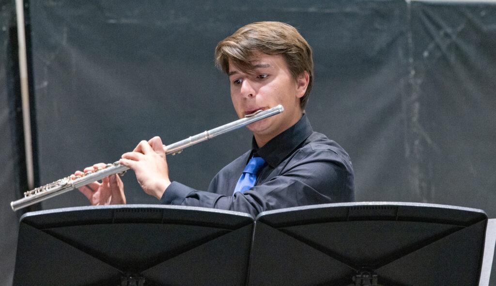 Petr+performs+a+flute+solo+in+a+chamber+ensemble+during+the+benefit+concert+on+March+5th.+