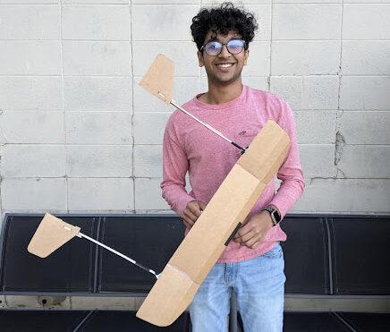 Senior Sajiv Shah holding a glider during a glider competition for new hires during his first week at WhisperAero. 