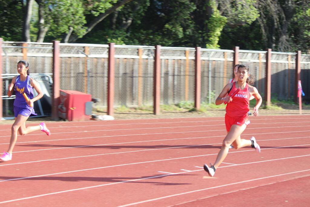 Junior Isha Jagadish sprints in a relay event as she competes against Monta Vista High School
