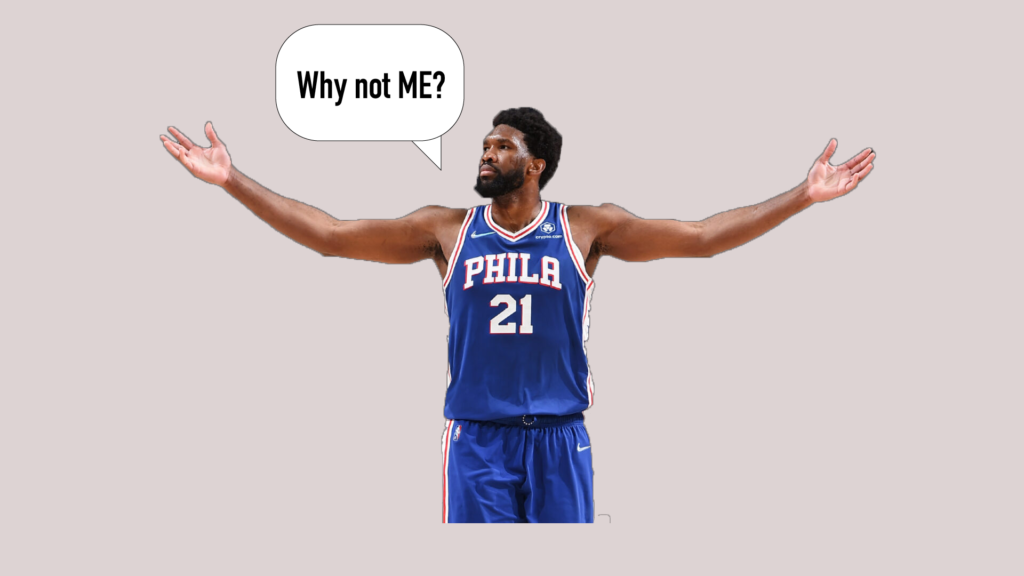Embiid celebrates his NBA regular season scoring title as he lifts his hands in the air.