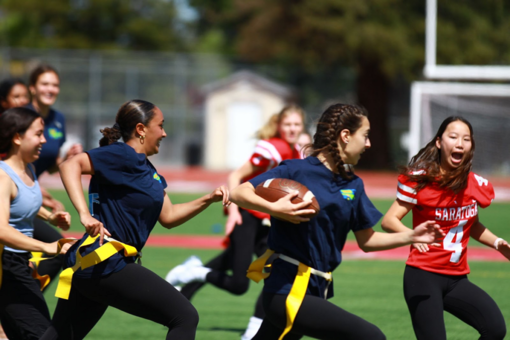 Junior Kayla Steele gains territory running with the ball during the Falconpuff championship game. The juniors were matched up against the seniors, who ultimately won 14-0.