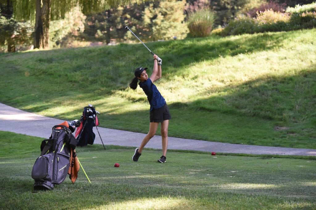 Senior Ananya Seth follows through on her swing, and watches the ball fly away from her.