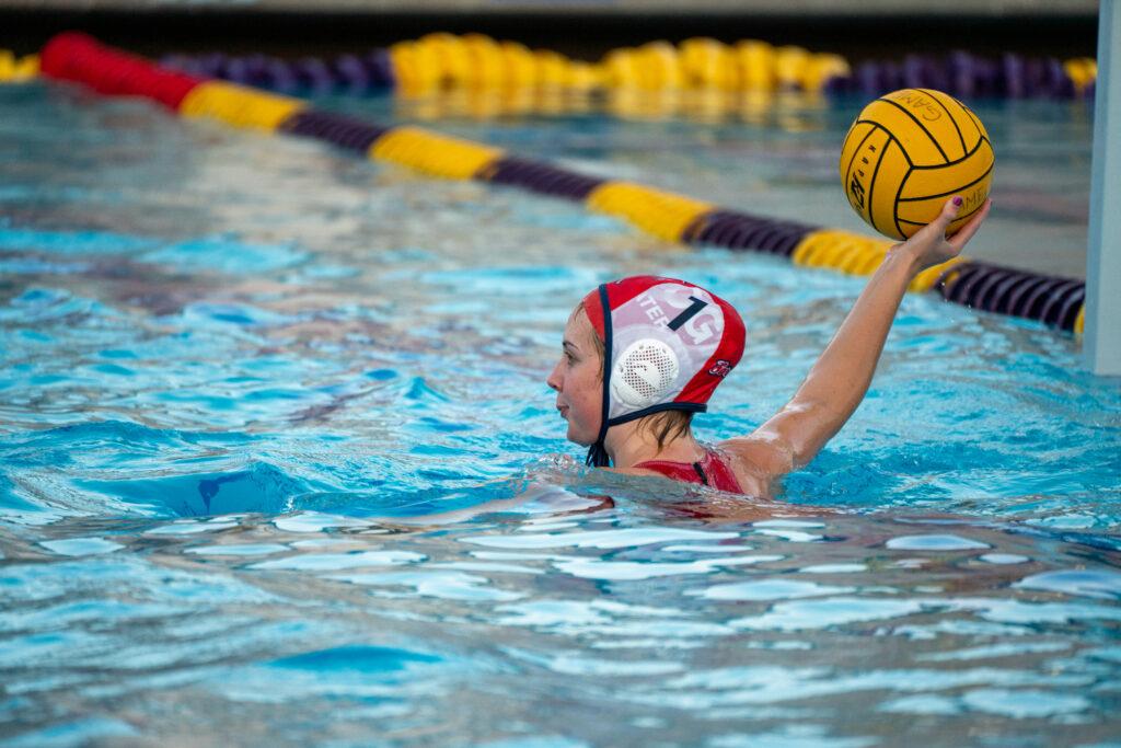 Senior goalie Rosie Kline looks across the pool for an open player