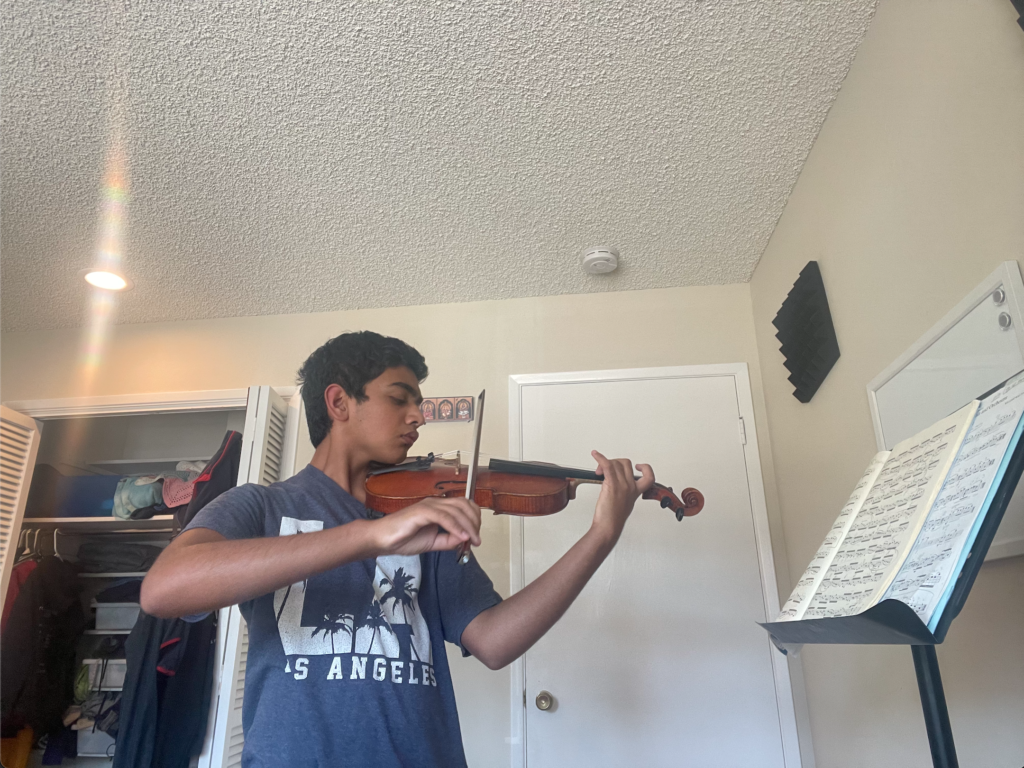 Junior Tejas Tirthapura practices his viola at home. 