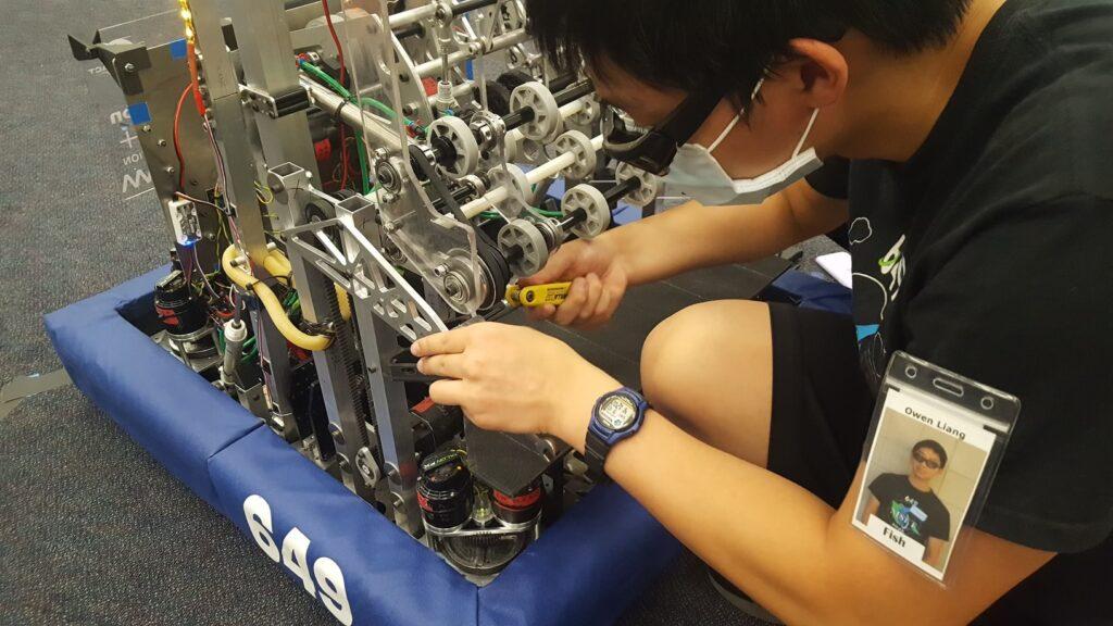 Junior Owen Liang mounts the new intake hardstop, preventing the intake from deploying too far down.