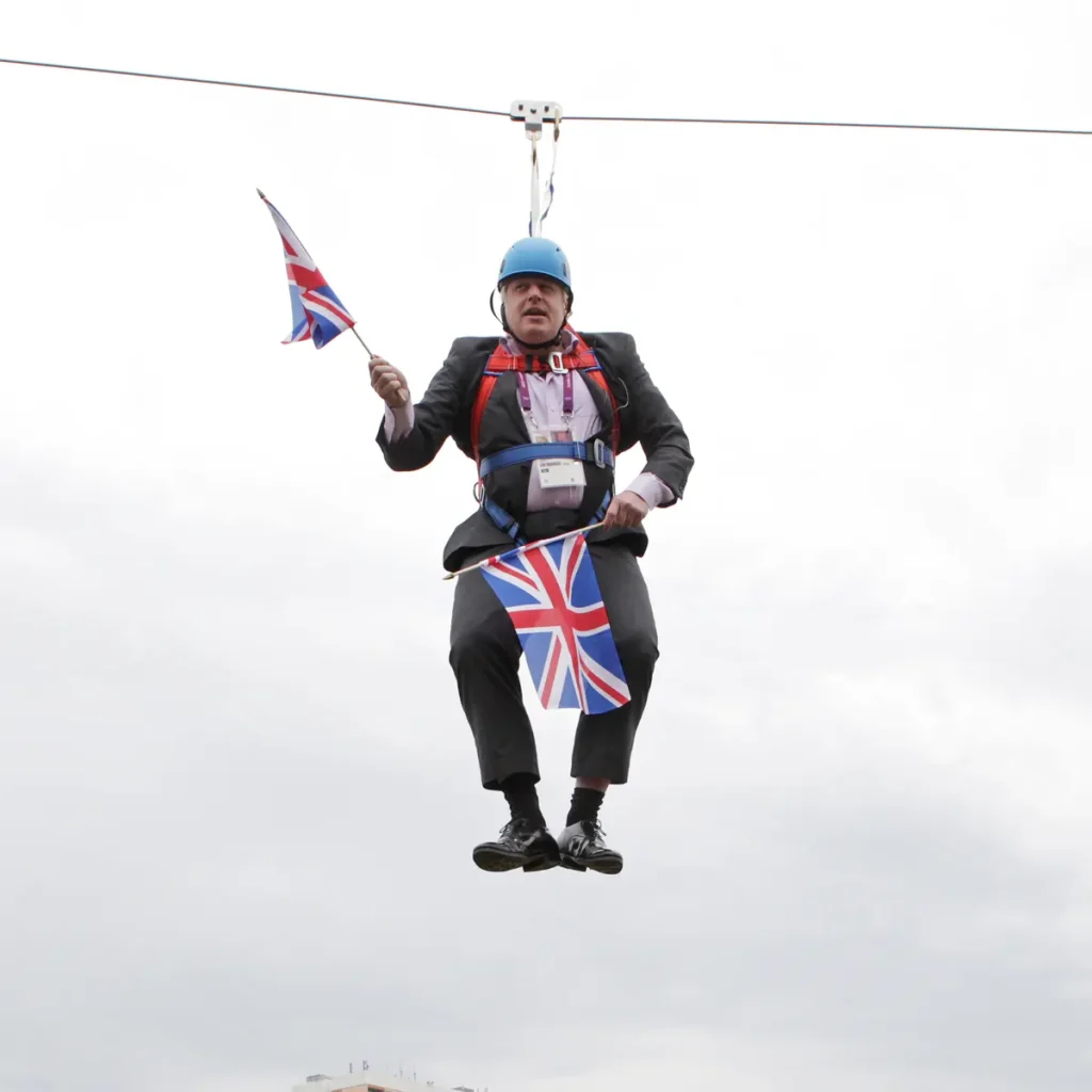 Former British prime minister Boris Johnson gets stuck on a zipline in 2012.