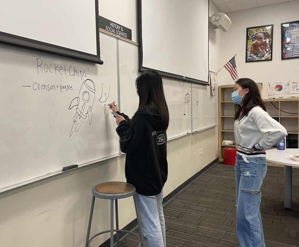 Presidents senior Kasie Yang and junior Angela Zhao design an example logo for the branding design project. 