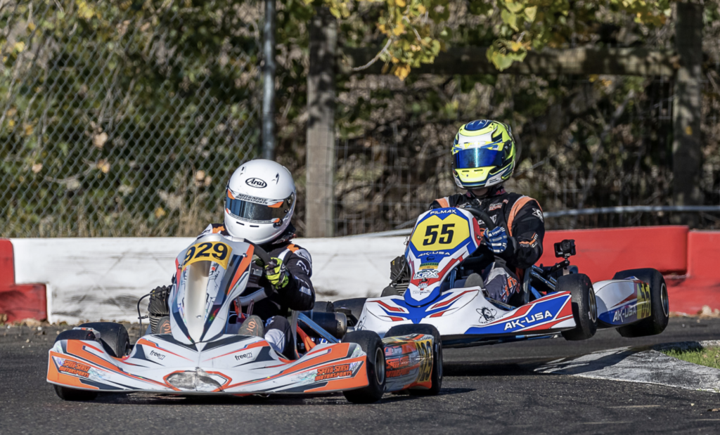 Kapoor (in front) rounds a sharp corner with another racer following close behind.