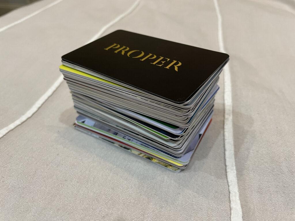 A hotel card collection stacked together, with the Proper Hotel card sitting at the top.