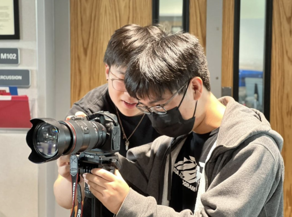  SHS TV head producer, senior Adam Xu, and Kai Otsuka, a first year reporter, set up an interview shot in M102.