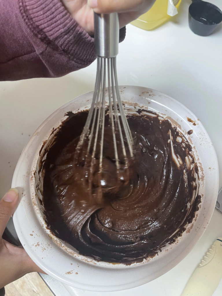 The process of mixing the brownie batter. 