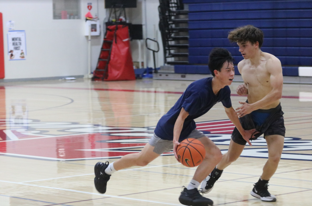 Sophomore Caleb Yu and junior Brooks Overton go head to head during a practice on Oct. 21.