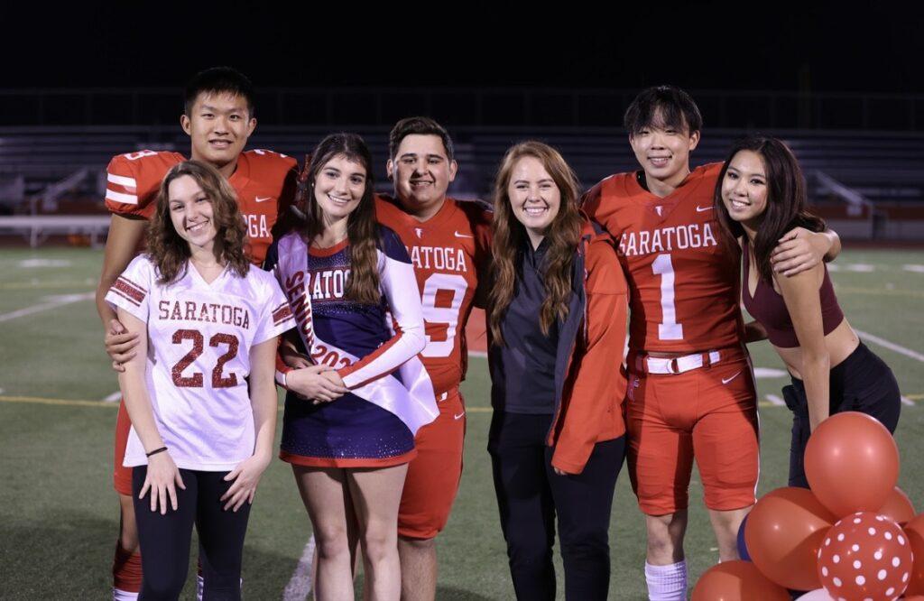 Athletic+trainer+Caitlin+Steiding+poses+with+the+football+team+during+the+football+game+senior+night.