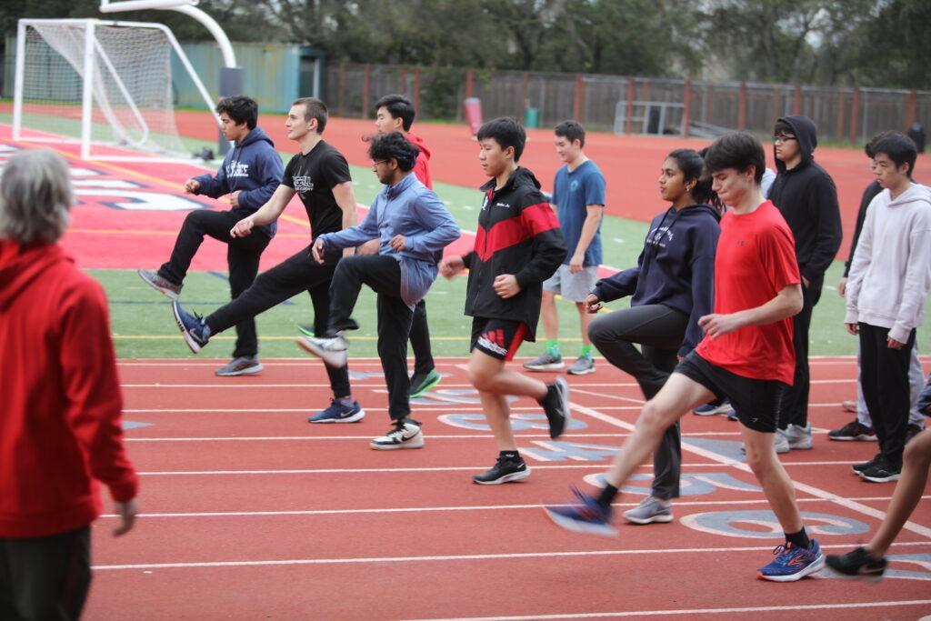 During a practice on Feb. 3, the sprinters do warm up drills.