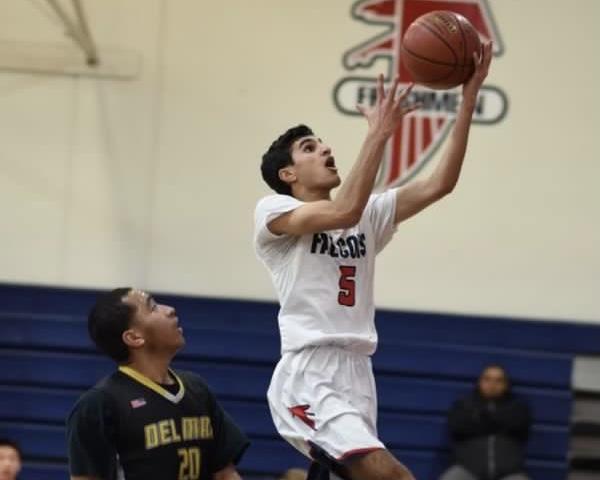 Class of ‘19 alumnus  Sehij Dhindsa goes up for a layup in 2019 during a senior year game.