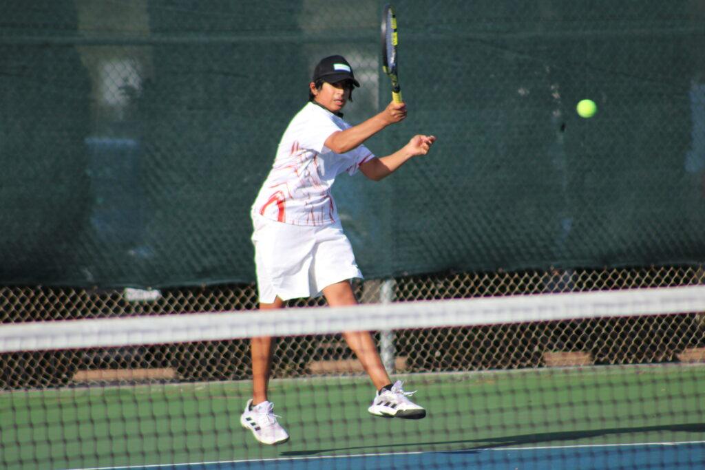 Freshman Nikhil Srivatsa completes a forehand while warming up for a match against Los Altos