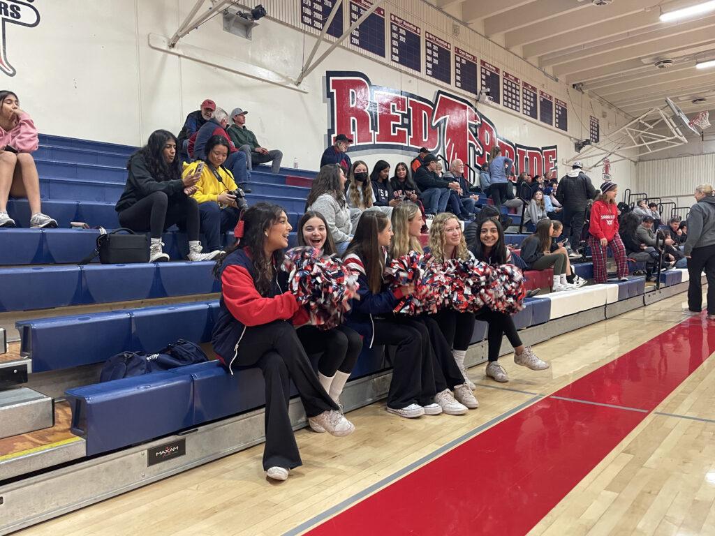 The+cheer+team+sits+on+the+edge+of+the+stands+preparing+to+cheer+for+the+girls%E2%80%99+basketball+on+their+Jan.+7+game+against+Los+Gatos.