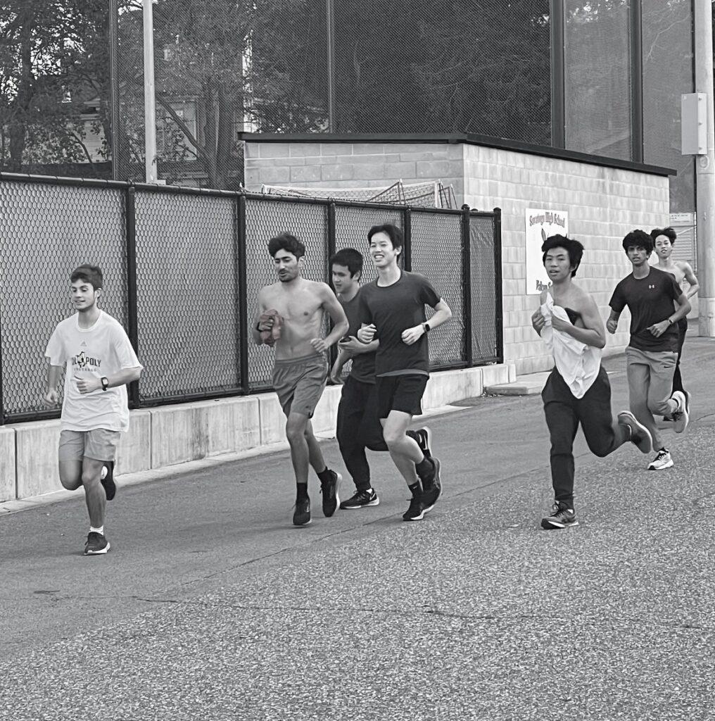 Boys on the track team run during practice.