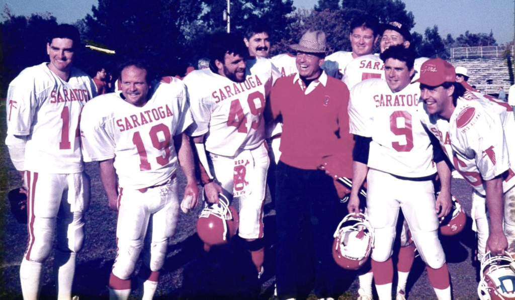 Alumni players Rick Worman, Rich Orlando, Kevin Ruf, Steve Worman, Larry Worman, Kevin Tanner, Rob Orlando and Kyle Heinrich (left to right) pose with coach Benny Pierce (center) at the annual Thanksgiving Turkey Bowl reunion game against Los Gatos on Nov. 26, 1992.