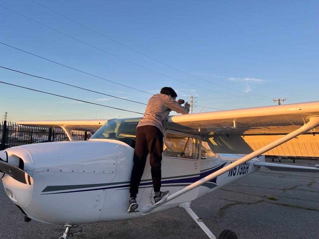Senior Anand Agrawal checks the fuel quantity in his plane.