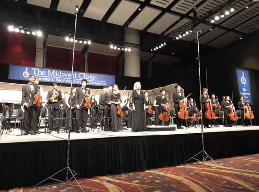 The 2018 Saratoga Strings stand up to bow after their performance at the Midwest Clinic.