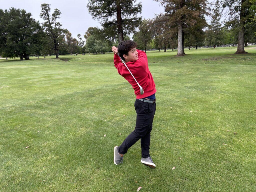 Sophomore+Aidan+Smith+hits+his+approach+shot+on+the+18th+hole+during+league+finals+at+Santa+Teresa+golf+course+en+route+to+a+birdie.