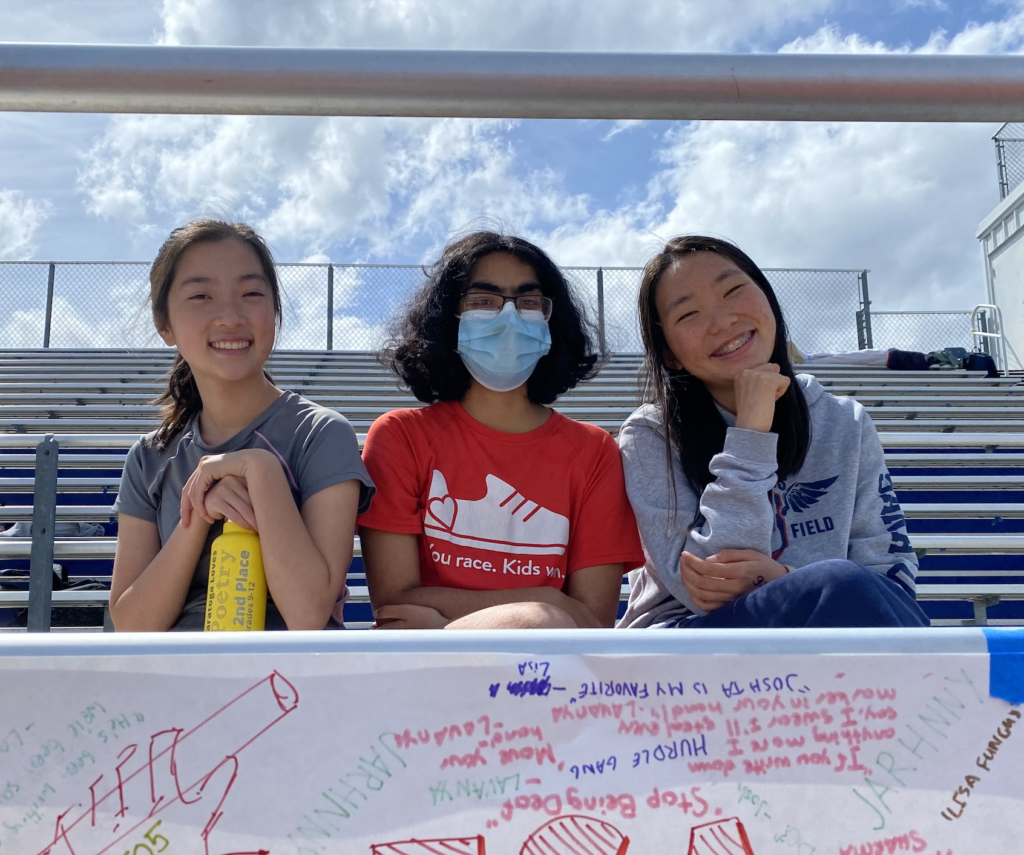 Left to right: Seniors Jenny Chan, Nithya Krishna and Carolyn Wang sit on the bleachers at theTrack and Field home meet on April 18.


