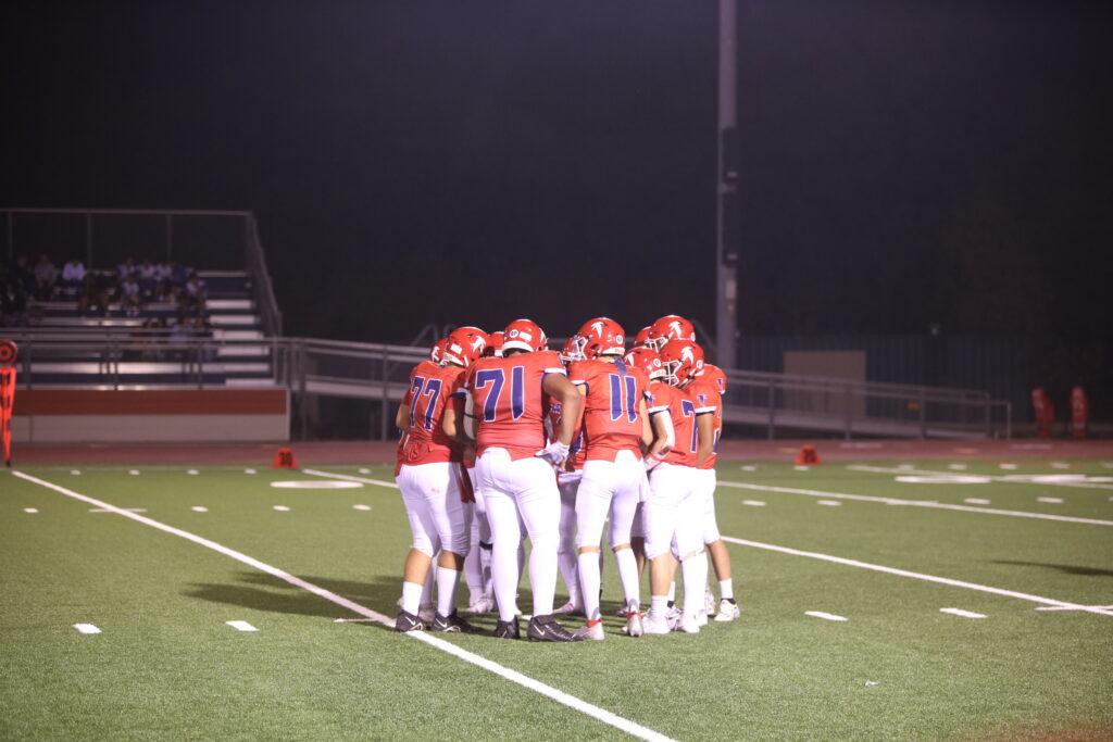 The team’s offense forms a huddle during the third quarter of the game against Santa Cruz on Sept. 1. The Falcons won 69-0.