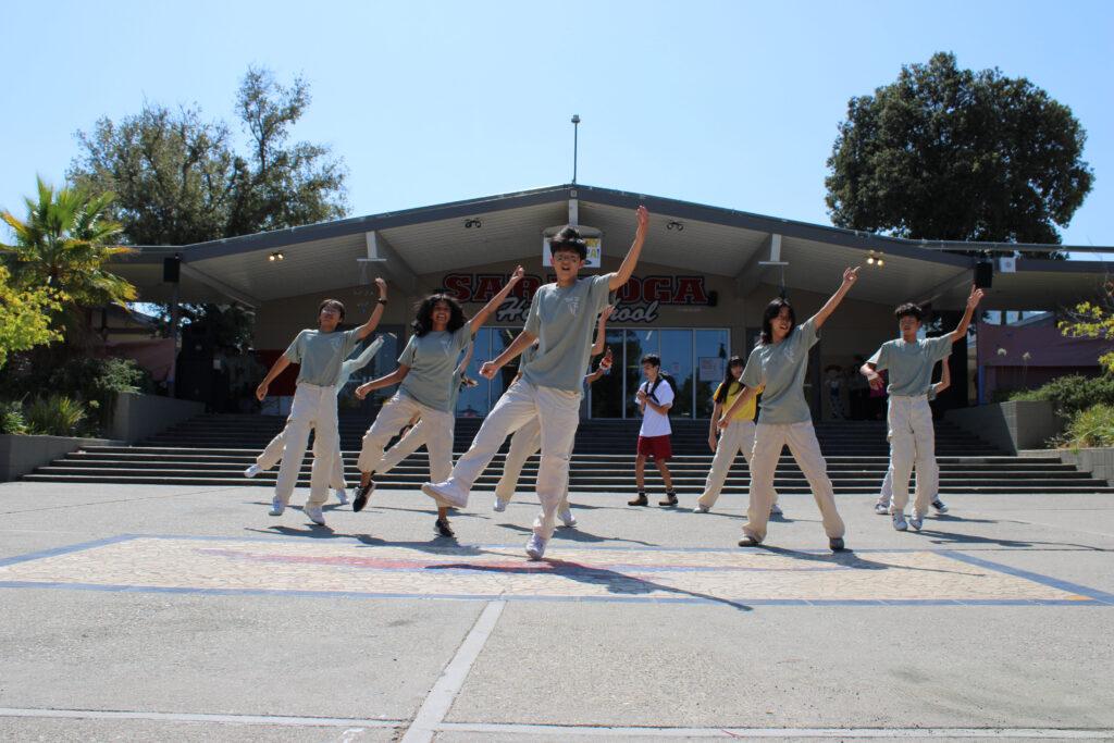 Freshmen point skyward in the K-pop dance.