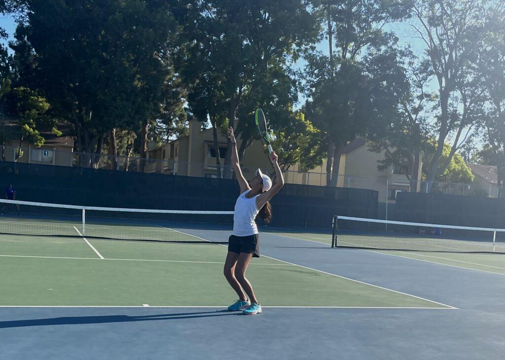 In their second match against Santa Clara, singles 1 player, Mihika Singh, lines up to serve for the match. The girls won 7-0.