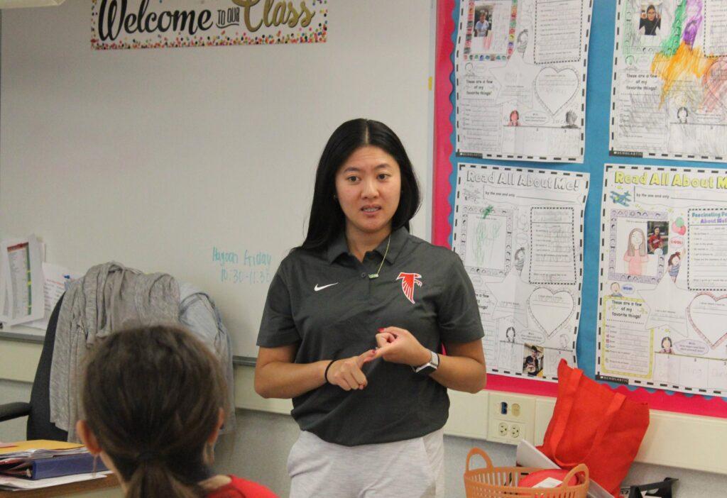 CBI teacher Michelle Nguyen shows students how to order food and behave in public in preparation for when they visit Big Burger Basin.