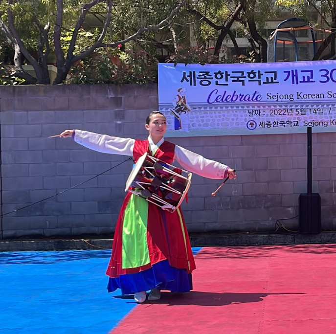 Senior+Hannah+Shaw+performs+a+dance+to+celebrate+the+30th+anniversary+of+the+Sejong+Korean+School.