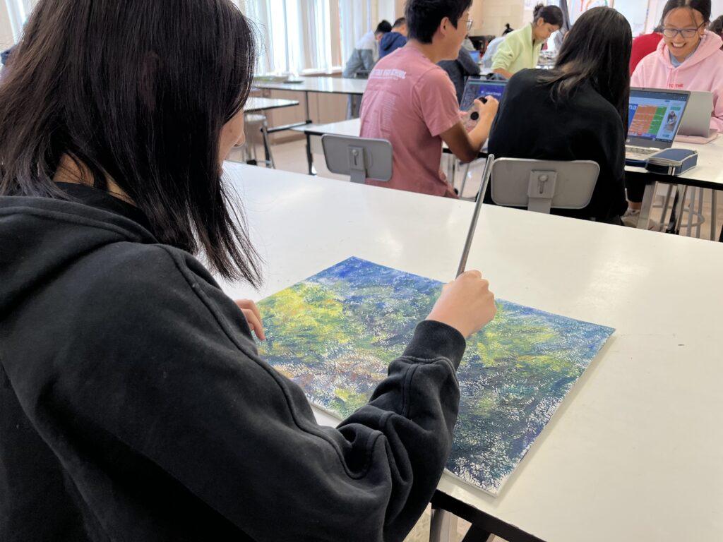 Senior Kayla Jung works on an untitled piece for her portfolio, “Textures of Home.”
