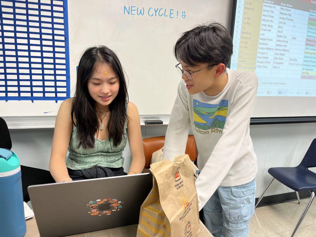Editors-in-chief Amy Pan and Timothy Leung discuss the yearbook cover’s design.