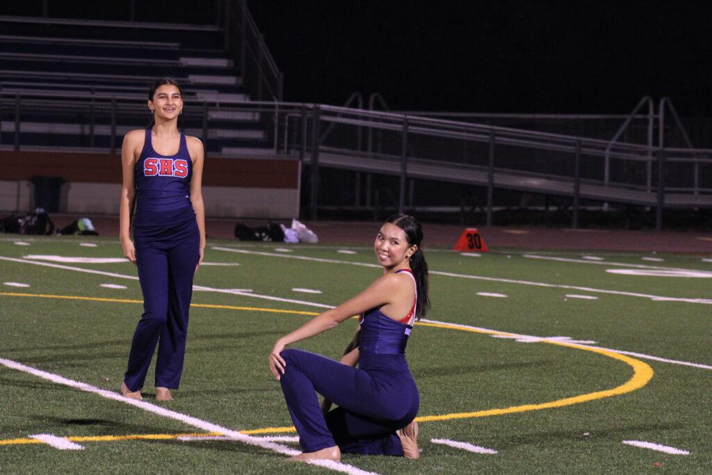The dance team members Anisa Taymuree and Annalyn Bui hold their ending pose for their Oct. 20 football game halftime performance.