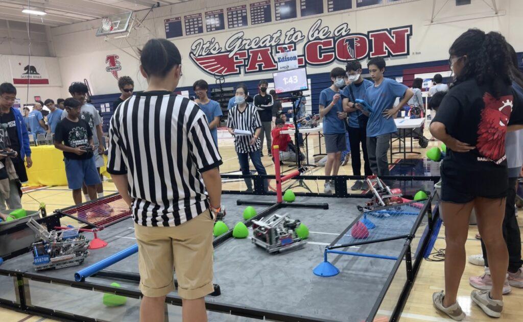 VEX robot drivers maneuver their robots through the field during a competition on Oct. 8 at the school’s big gym.