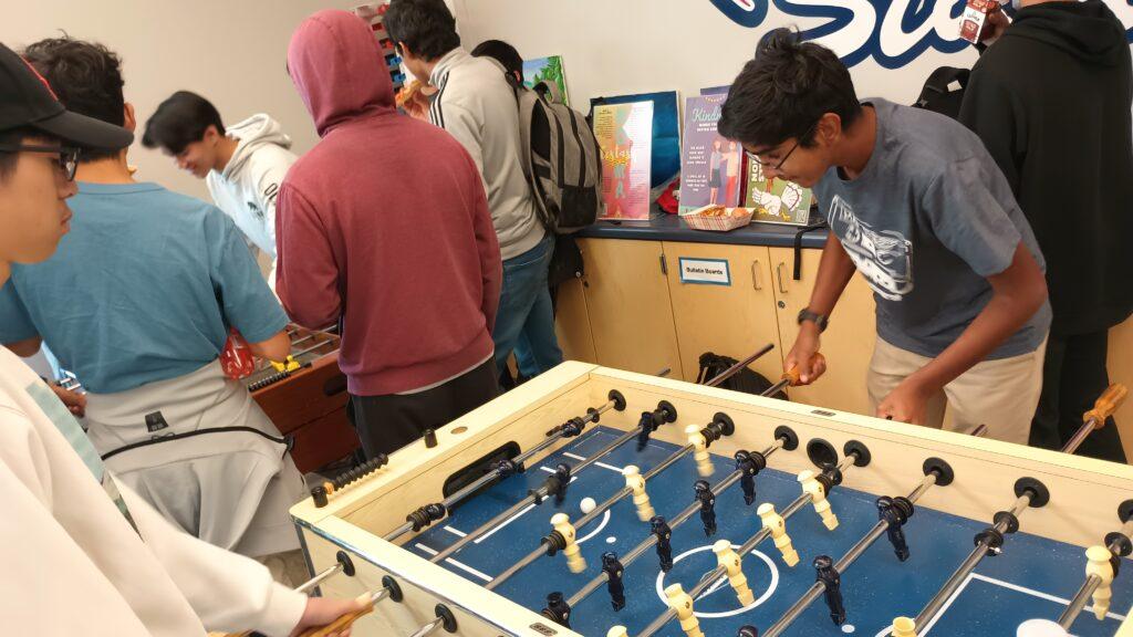 Sophomore Garrick Chau faces off against his opponent in a foosball match.