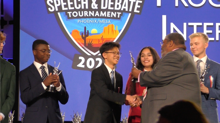 Timothy Leung accepts his trophy for reaching the semifinals for Program Oral Interpretation.