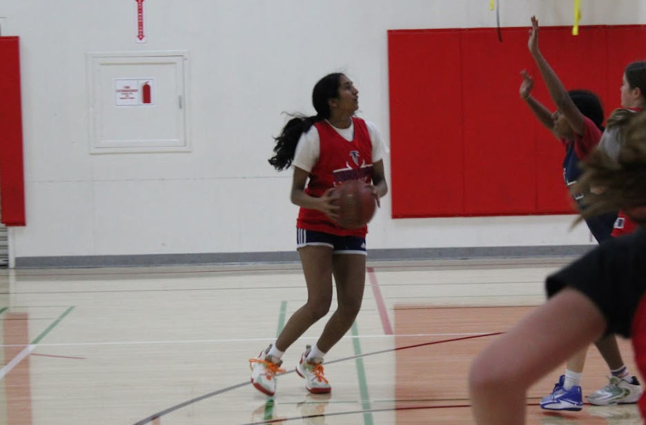 Junior point guard Urvi Iyer prepares to take a shot during a team practice game.