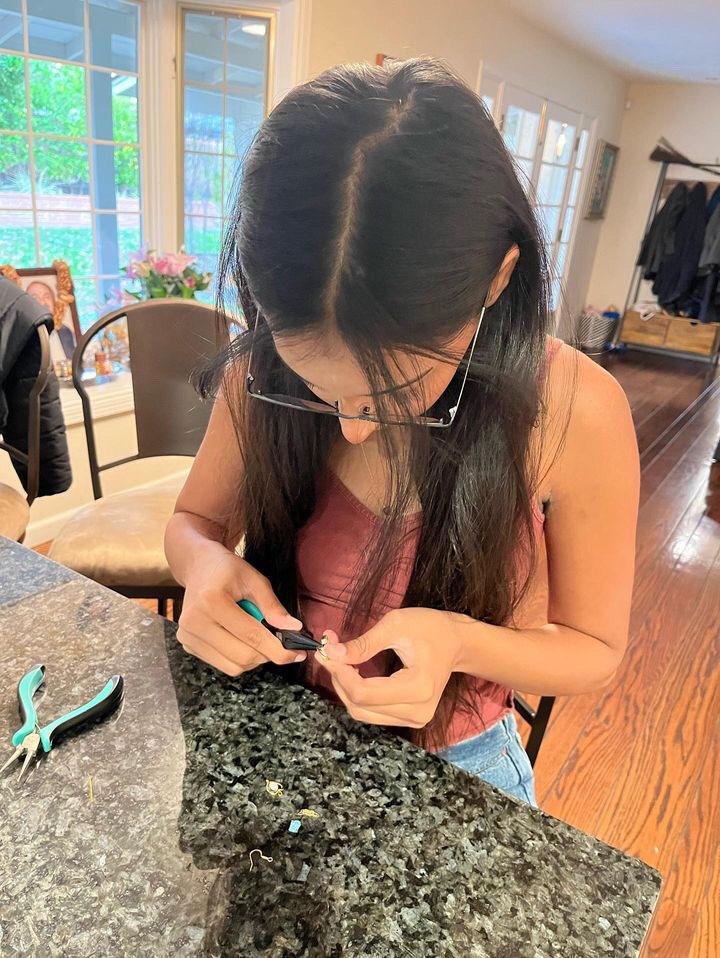 Junior Rani Khanna tweezes metal pieces together for a batch of earrings over Thanksgiving break. 