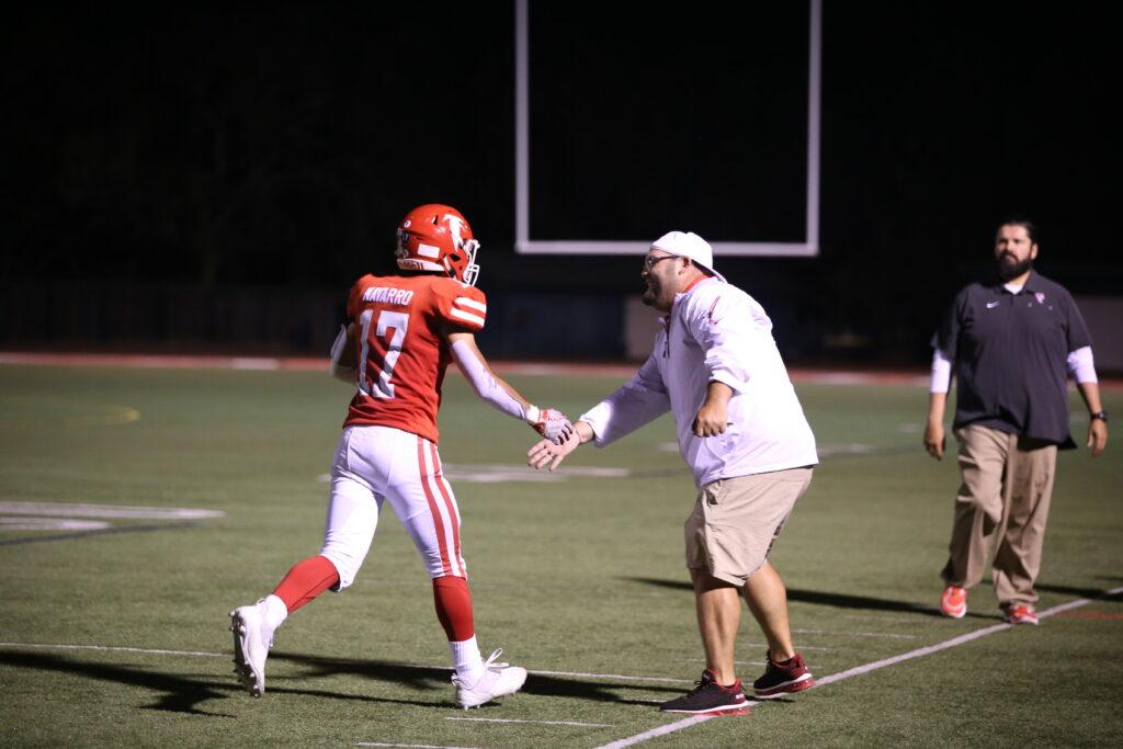 During the Homecoming game in 2021, coach Steven Matos encourages a player coming to the sideline.