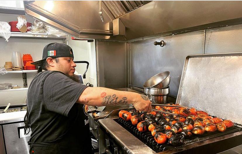 One of the chefs from Kito’s Taco Shop, Juan, grills tomatoes for the salsa.