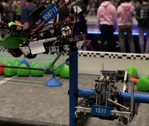 Team 95071X executes their H-tier hang with their alliance partner 151T in their division quarterfinals match.