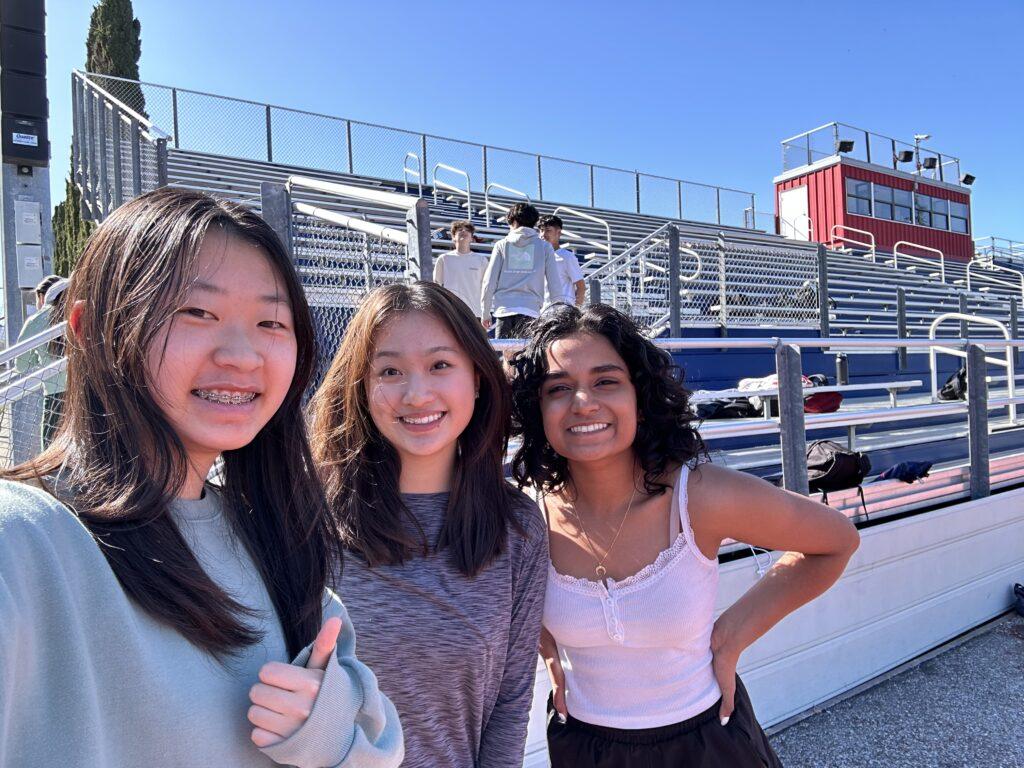 Juniors Nicole Lee, Amy Pan, and Anjali Biju getting ready for a track warmup.