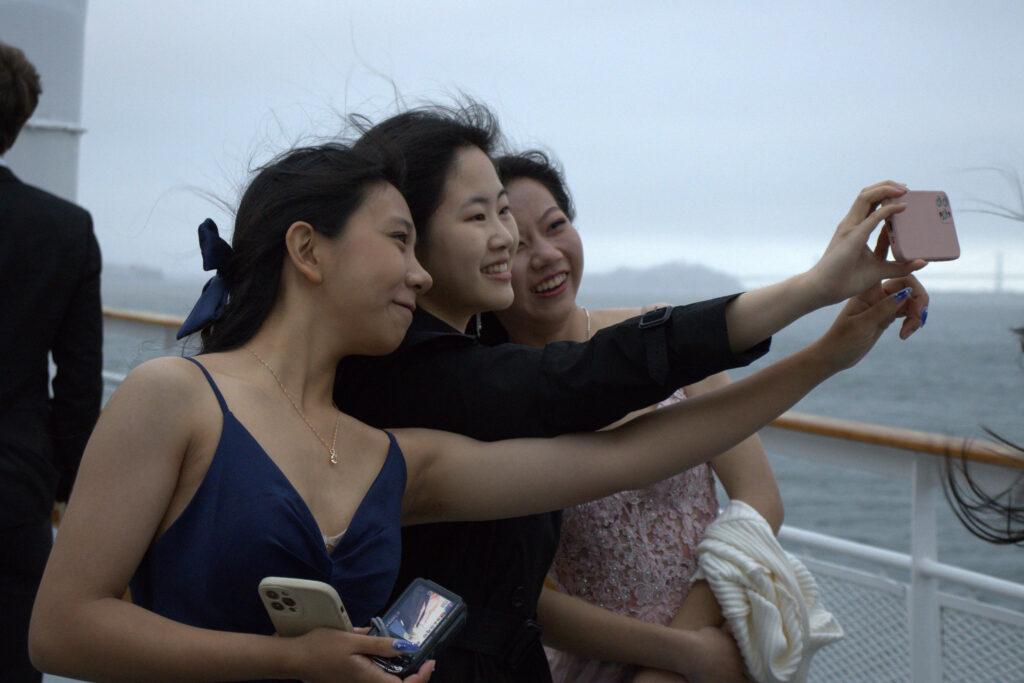 Seniors Sophia Deng, Cherilyn Hu and Grace Li pose for a selfie together on the deck.